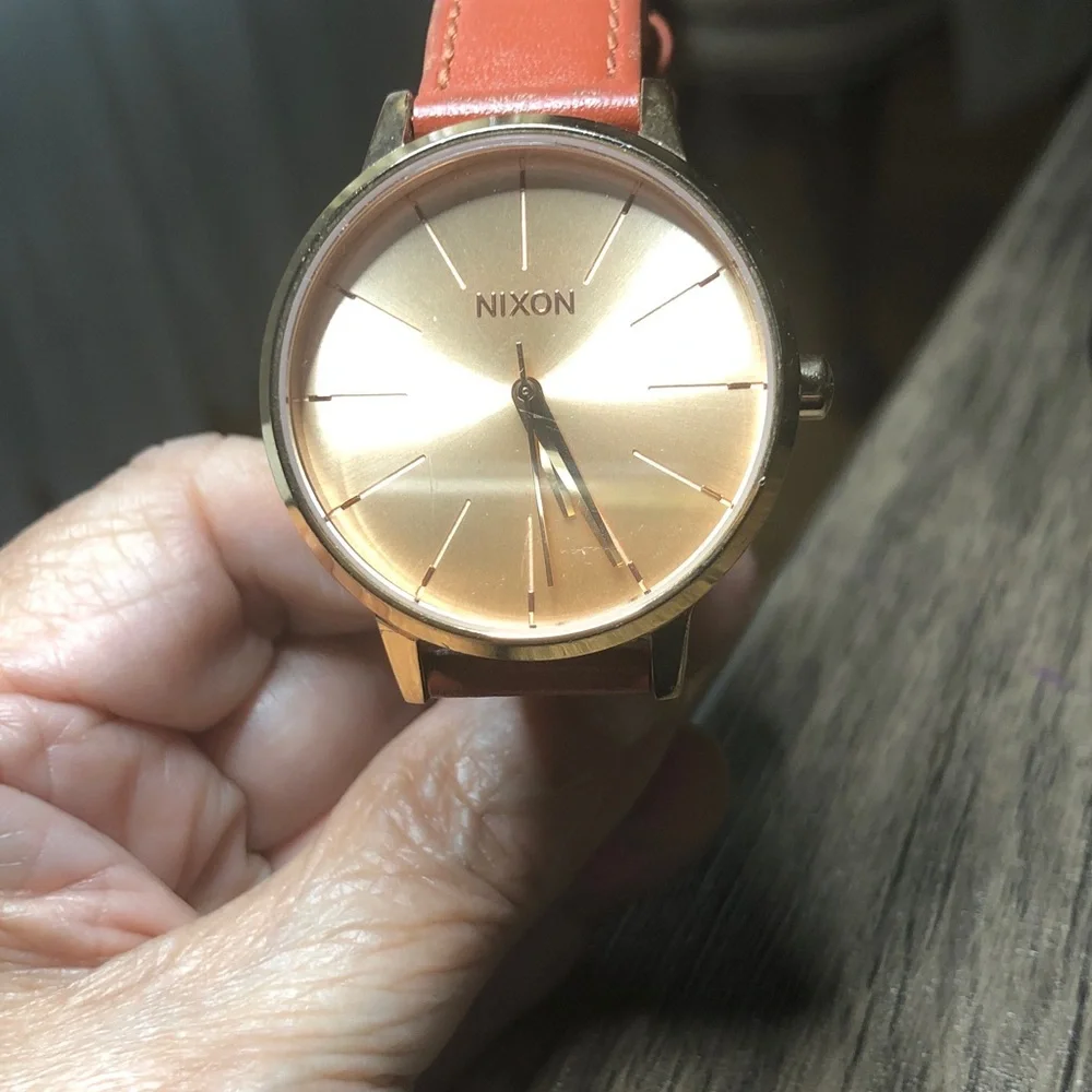 Nixon watch with box instructions and extra black strap.  Woman’s watch.